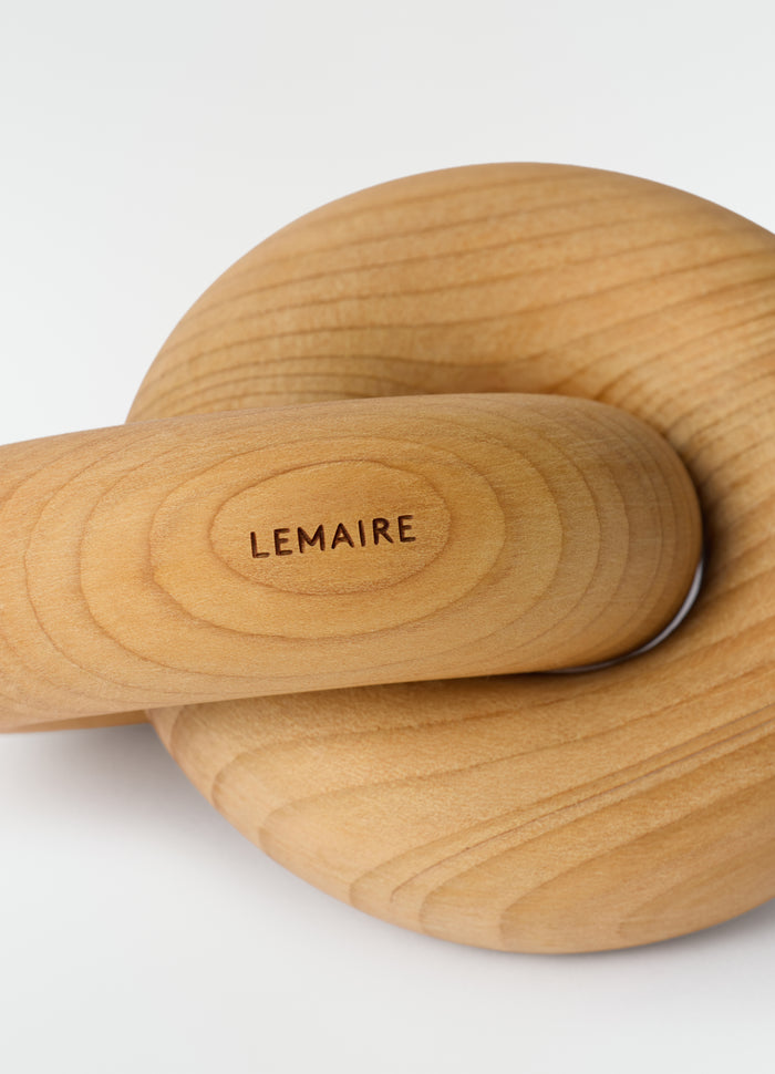 Wood Link M wooden accessory in natural tone with LEMAIRE engraving close-up on plain white background