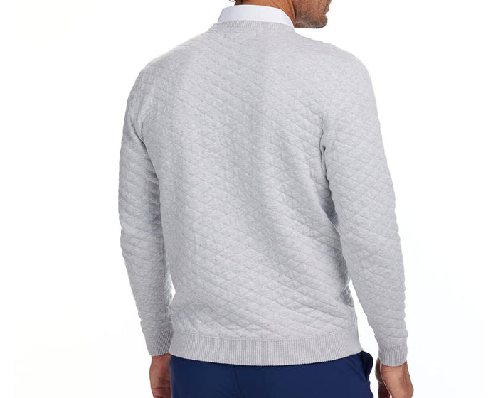 Man wearing Yale Golf Course Ward Sweater in heathered gray with diamond quilting, over white shirt, part of limited edition Holderness & Bourne collection.